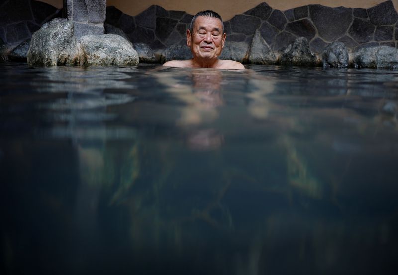 © Reuters. Customer soaks himself in a bath at public bathhouse in Toyko