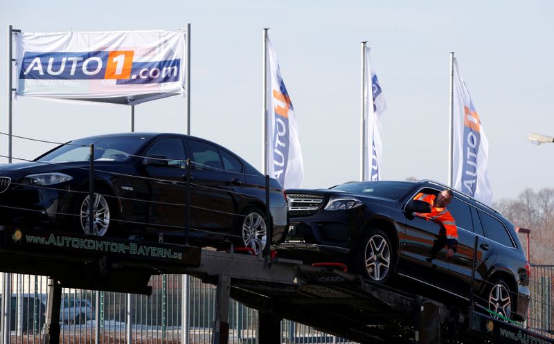 &copy; Reuters. A worker loads a second hand car on a car transporter truck at the Auto1.com company grounds in Zoerbig