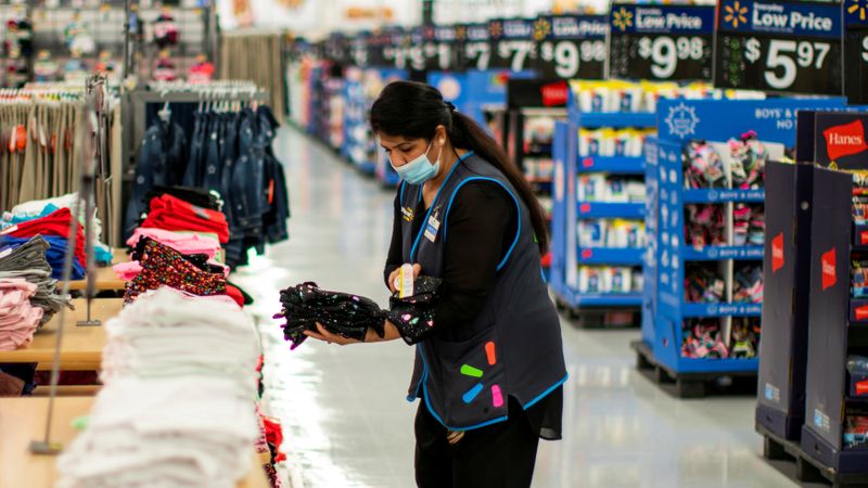 &copy; Reuters. FILE PHOTO: A worker is seen wearing a mask while organizing merchandise at a Walmart store, in North Brunswick, New Jersey