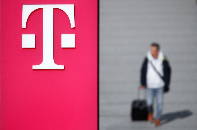 &copy; Reuters. A man walks past the logo of Deutsche Telekom AG at the headquarters of German telecommunications giant in Bonn