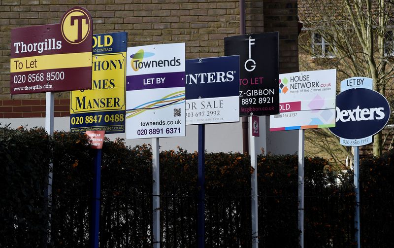 © Reuters. FILE PHOTO: Property estate agent sales and letting signs are seen attached to railings in London, Britain