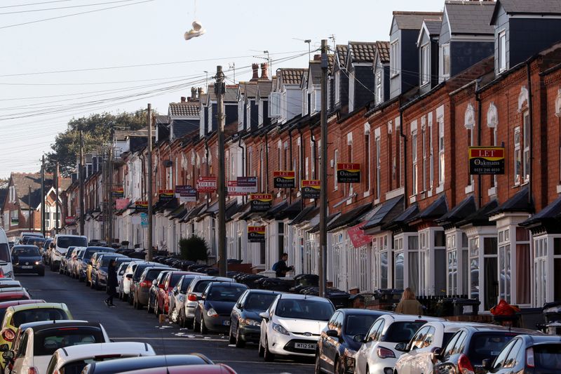 &copy; Reuters. FILE PHOTO: Estate agent&apos;s signs hang from houses in the Selly Oak area of Birmingham