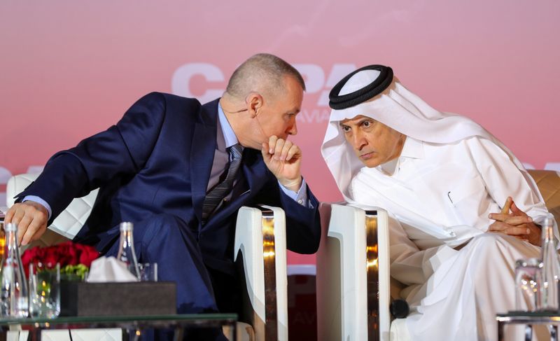 © Reuters. FILE PHOTO: Qatar Airways Chief Executive Akbar Al Baker and International Airlines Group (IAG) counterpart Willie Walsh at a conference in Doha