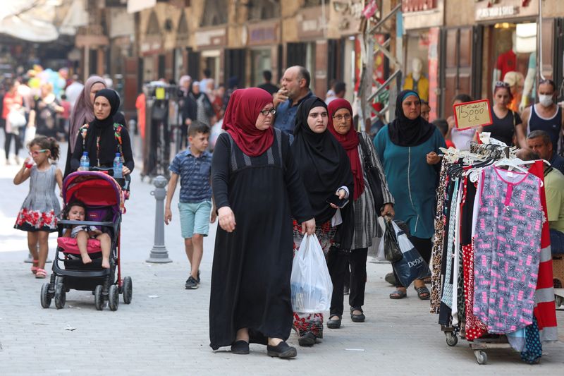 &copy; Reuters. People walk at a souk ahead of the Eid al-Adha celebrations in Tripoli