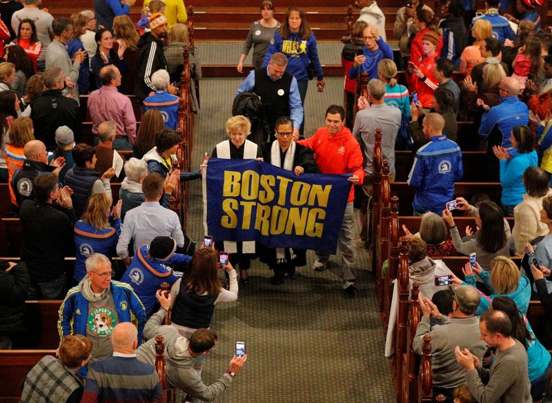 &copy; Reuters. Boston Marathon bombing witness Carlos Arredondo blesses the runners during a service at Old South Church in Boston