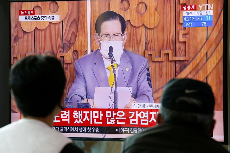 &copy; Reuters. People watch a TV broadcasting  a news report on a news conference held by Lee Man-hee, founder of the Shincheonji Church of Jesus the Temple of the Tabernacle of the Testimony, in Seoul