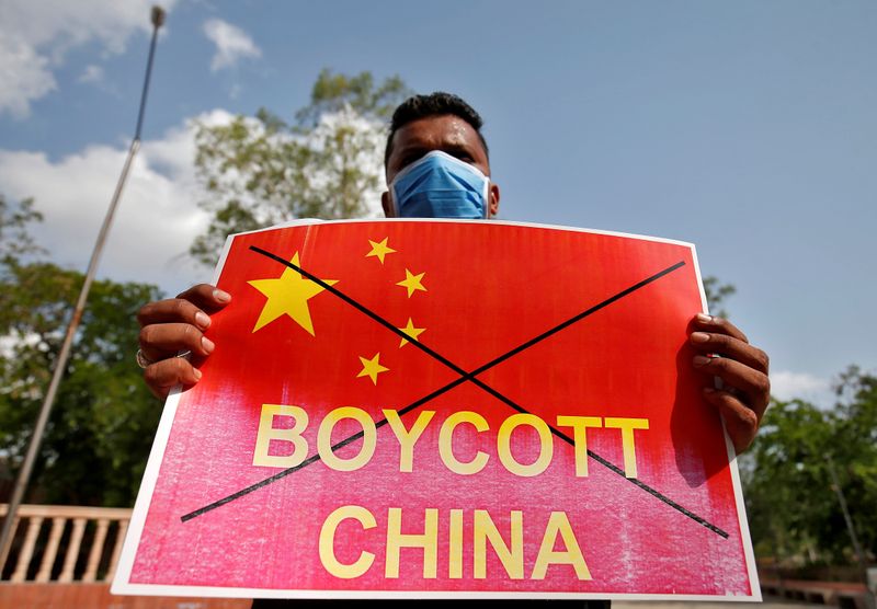 &copy; Reuters. FILE PHOTO: Member of NSUI holds a placard during a protest against China, in Ahmedabad