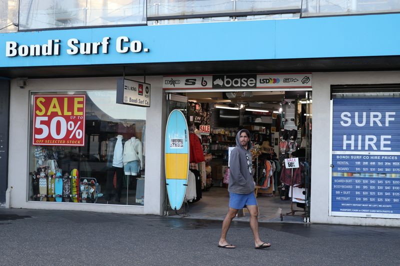 &copy; Reuters. A man walks past a retail shop at Bondi Beach in Sydney