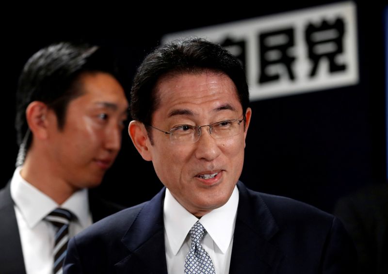 &copy; Reuters. Japan&apos;s ruling Liberal Democratic Party policy chief Kishida smiles as he arrives at the LDP headquarters in Tokyo