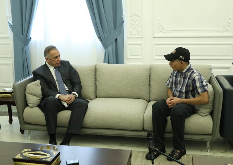 &copy; Reuters. Iraqi Prime Minister Mustafa al-Kadhimi meets with Iraqi teenager Hamid Saeed, who was mistreated by members of security forces, after he was released from jail in Baghdad