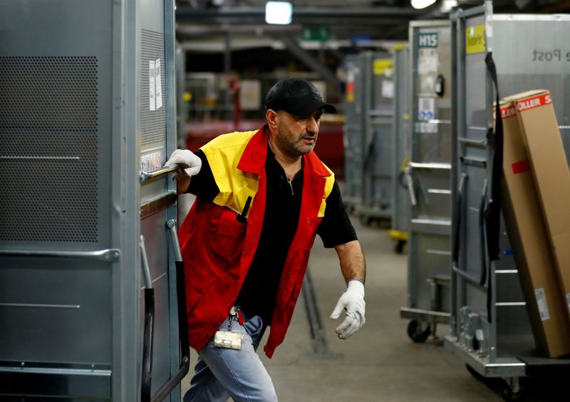&copy; Reuters. FILE PHOTO: An employee works at a distribution centre of German postal and logistics group Deutsche Post DHL in Rodgau