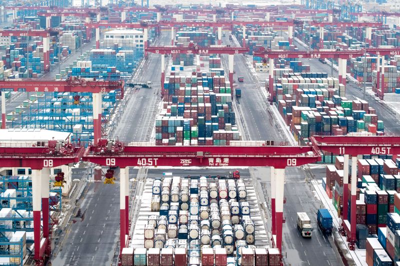 &copy; Reuters. Containers and trucks are seen following a snowfall at the port of Qingdao, Shandong