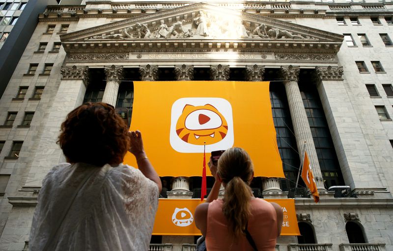 &copy; Reuters. People take pictures of the Huya Inc. logo ahead of the company&apos;s IPO at the New York Stock Exchange (NYSE) in New York