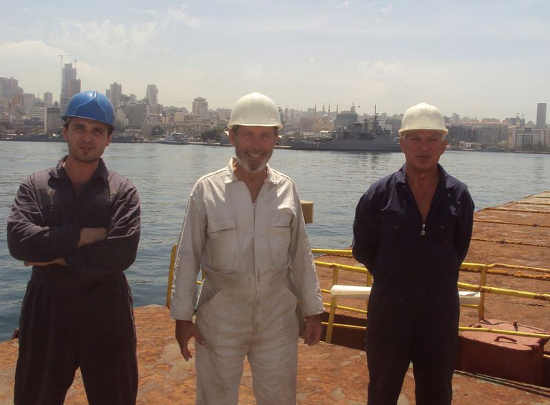 &copy; Reuters. Boris Prokoshev, captain of cargo vessel Rhosus , boatswain Boris Musinchak and a crew member pose in the port of Beirut