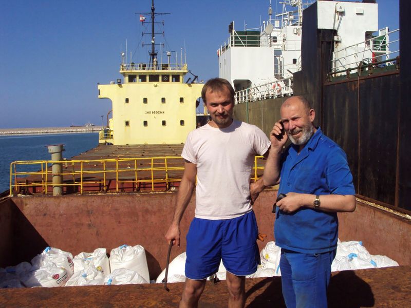 &copy; Reuters. Boris Prokoshev, captain of cargo vessel Rhosus, and boatswain Boris Musinchak pose next to a freight hold in Beirut