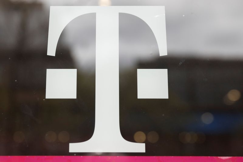 &copy; Reuters. FILE PHOTO:  A T-Mobile logo is seen on the storefront door of a store in Manhattan