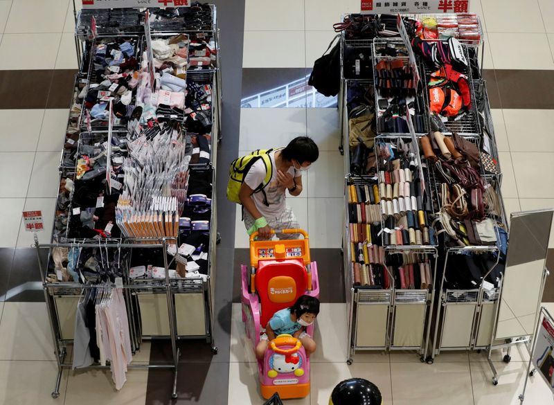 &copy; Reuters. FILE PHOTO: A shopper looks at goods at Japan&apos;s supermarket group Aeon&apos;s shopping mall as the mall reopens amid the coronavirus disease (COVID-19) outbreak in Chiba
