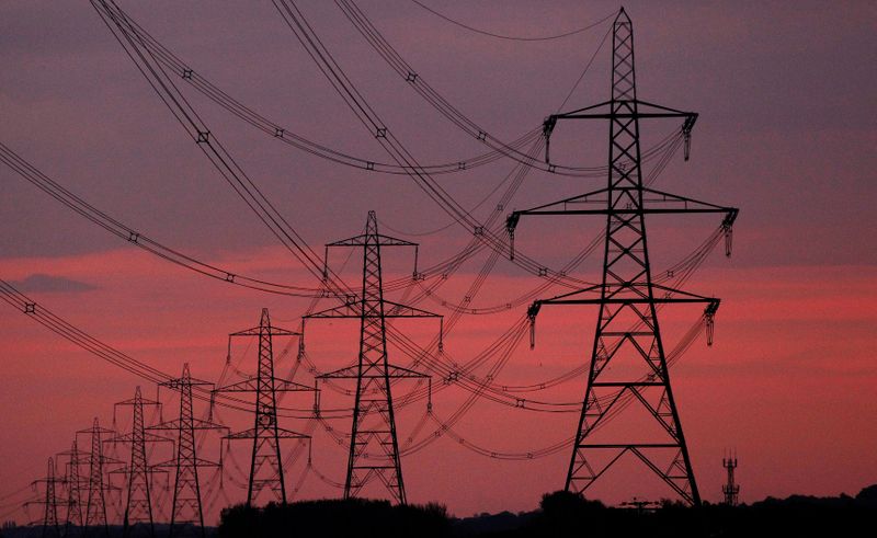 &copy; Reuters. FILE PHOTO: The sun rises behind electricity pylons near Chester