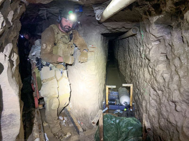 © Reuters. A U.S. Customs and Border Protection agent maps tunnel to Tijuana