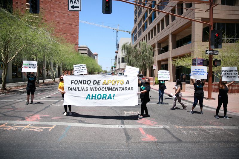 &copy; Reuters. FILE PHOTO: Protesters demand a relief fund for undocumented people during the coronavirus disease (COVID-19) crisis outside Phoenix City Hall