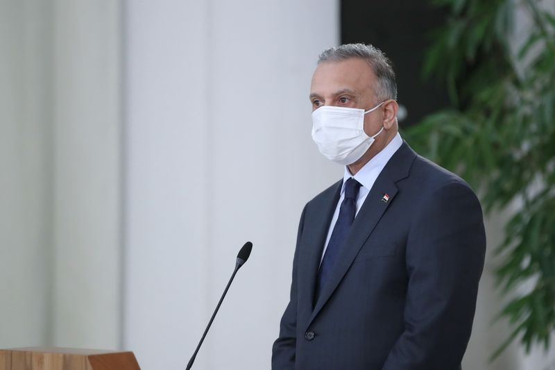 © Reuters. Iraqi Prime Minister Mustafa al-Kadhimi attends a news conference with Iranian President Hassan Rouhani as he wears a protective mask, in Tehran