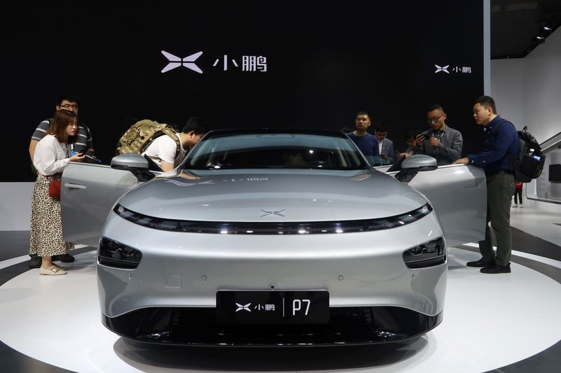 &copy; Reuters. People look at XPeng&apos;s P7 sedan model displayed at the Guangzhou auto show in Guangzhou
