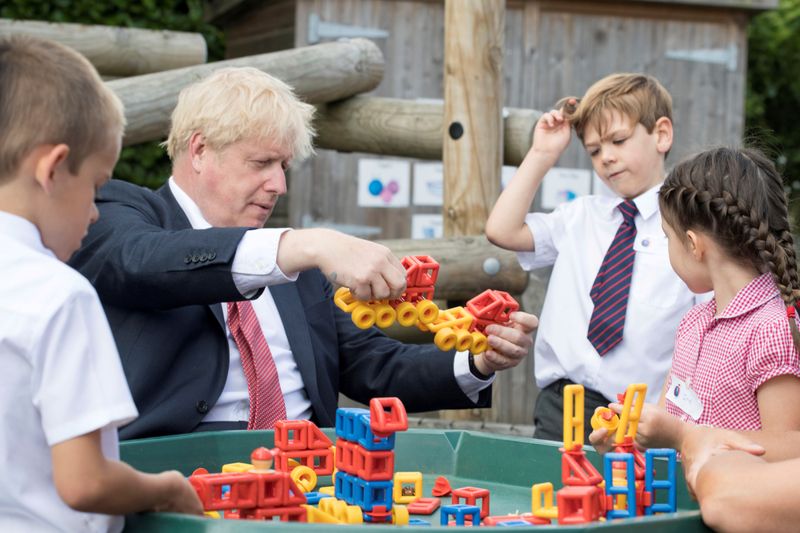 &copy; Reuters. FILE PHOTO: Britain&apos;s PM Johnson visits school in Kent