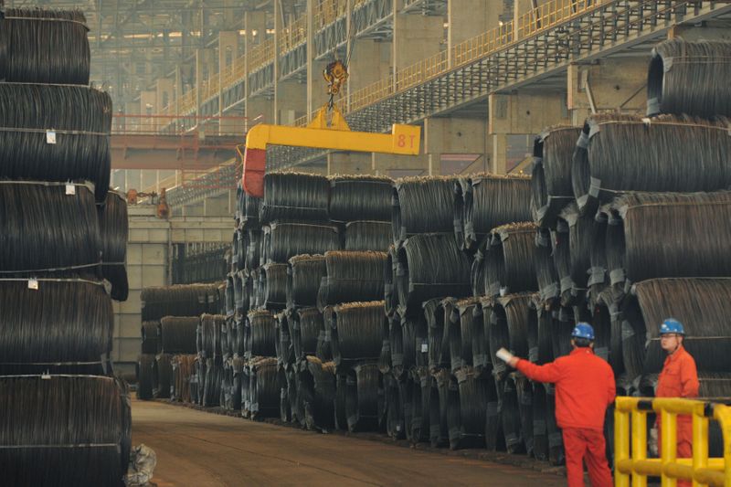 &copy; Reuters. Employees work next to steel wires at a Dongbei Special Steel plant in Dalian