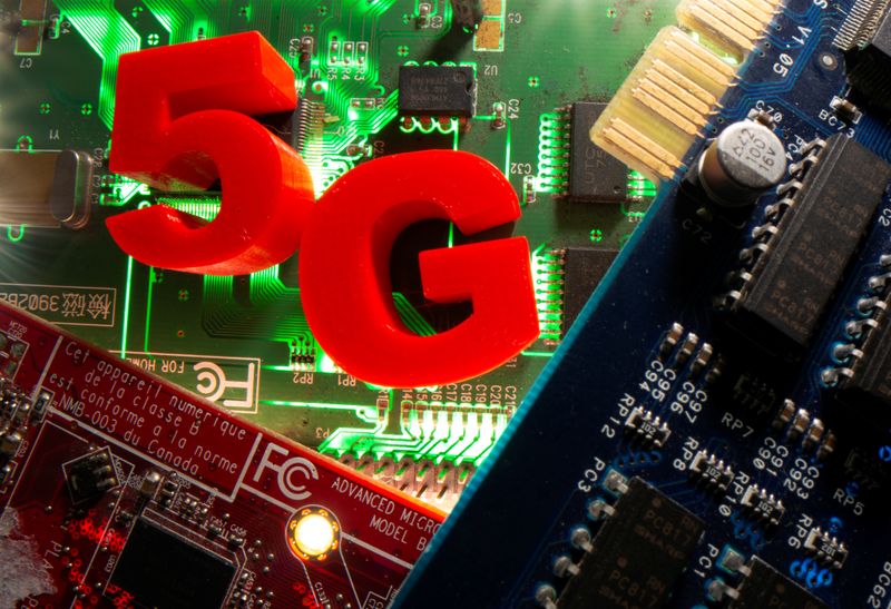 © Reuters. 3d printed objects representing 5G are put on a motherboard in this picture illustration