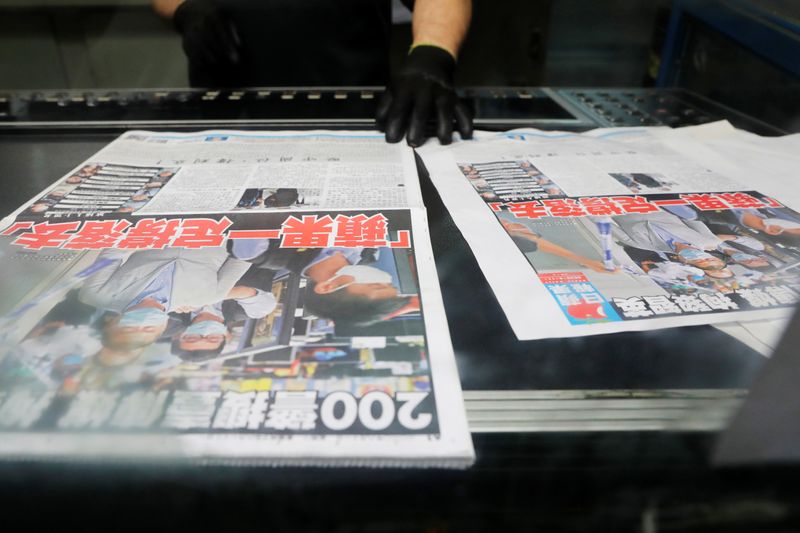 &copy; Reuters. An employee checks the print quality of copies of the Apple Daily newspaper, published by Next Media Ltd, with a headline &quot;Apple Daily will fight on&quot; at the company&apos;s printing facility, in Hong Kong