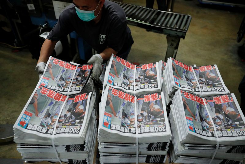 © Reuters. Bundles of the Apple Daily newspaper, published by Next Media Ltd, with a headline 