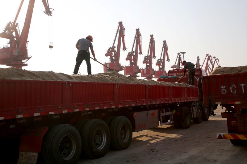 &copy; Reuters. Men work on transporting nickel laterite ore on a truck at Ganyu port in Lianyungang
