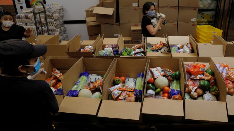 &copy; Reuters. Workers prepare free food for distribution at the Chelsea Collaborative in Chelsea