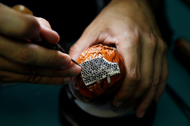 © Reuters. Custom-made, diamond encrusted gold coronavirus mask, being made in Israel