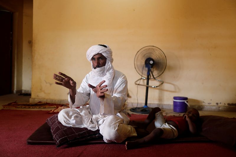 © Reuters. Algateig Mohamed, who fled Inates town with his family to escape jihadist violence, gestures during an interview with Reuters journalists as he sits at his shelter in Niamey