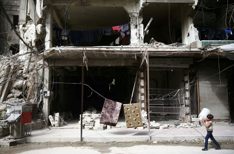 © Reuters. FILE PHOTO: A boy is seen in the besieged town of Douma, Eastern Ghouta, in Damascus