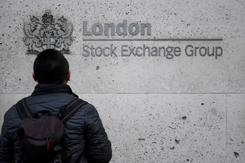 © Reuters. FILE PHOTO: A pedestrian in front of the London Stock Exchange offices