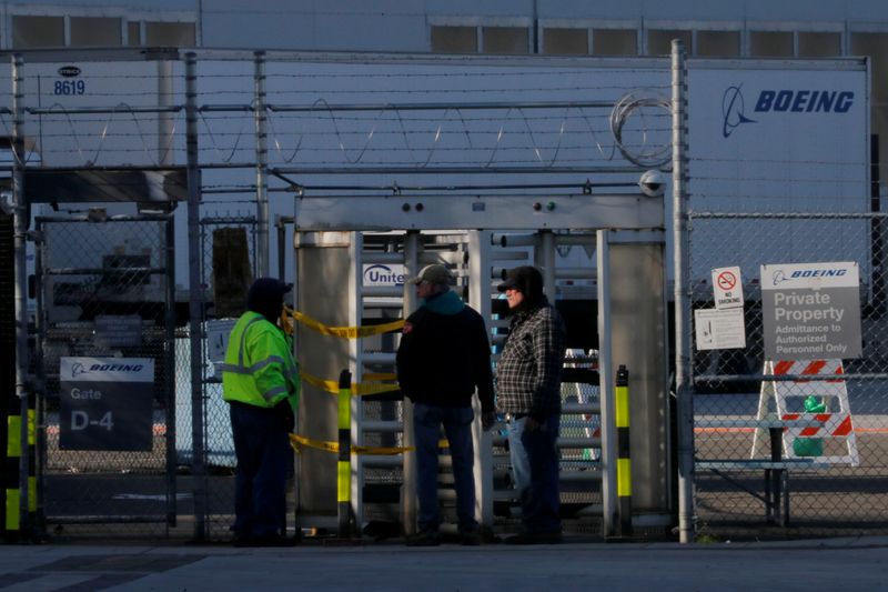 &copy; Reuters. Employees and contractors stand at a gate to the Boeing Renton Factory, in Renton, Washington