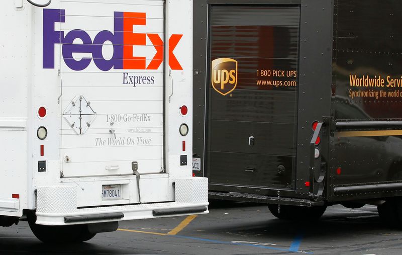 &copy; Reuters. A FedEx truck is parked next to a UPS truck as both drivers make deliveries in downtown San Diego