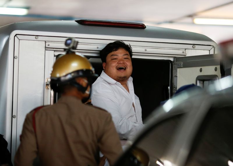 &copy; Reuters. Parit Chiwarak, a pro-democracy student, one of the leaders of Thailand&apos;s recent anti-government protests, reacts as he is being send to the court, at the police station in Bangkok