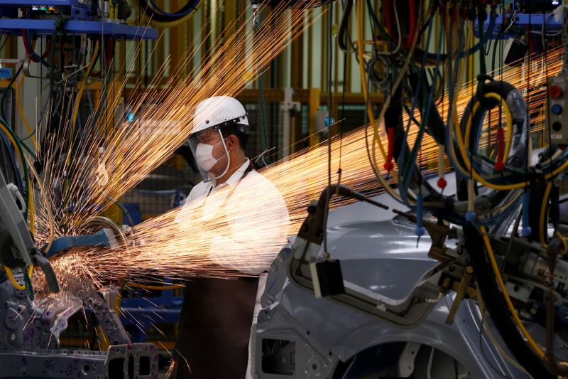 &copy; Reuters. A man works in the automobile production line of the new Honda plant in Prachinburi