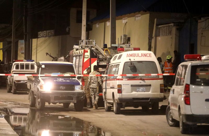 &copy; Reuters. Emergency vehicles are seen at a cordoned off area near the site of a blast at the Elite Hotel in Lido beach in Mogadishu