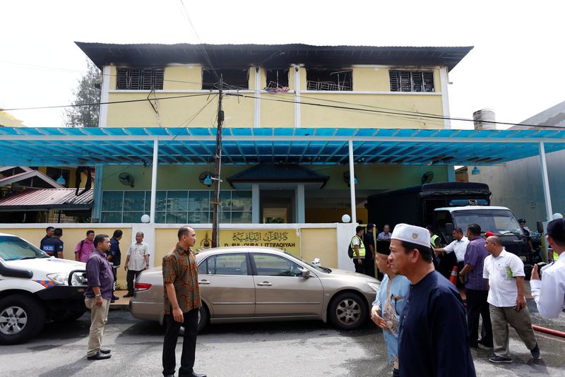 &copy; Reuters. FILE PHOTO: Authorities work at religious school Darul Quran Ittifaqiyah after a fire broke out in Kuala Lumpur