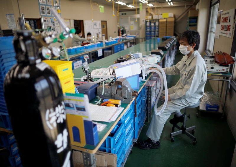 &copy; Reuters. Employees of Sanko Manufacturing Co. are seen at the assemble line of the company&apos;s ventilators at the factory in Saitama