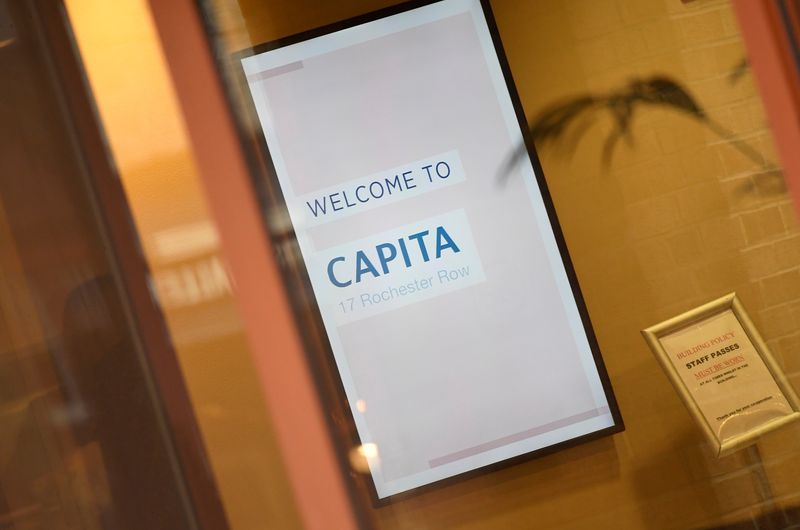&copy; Reuters. An illuminated sign is seen in Capita offices in London