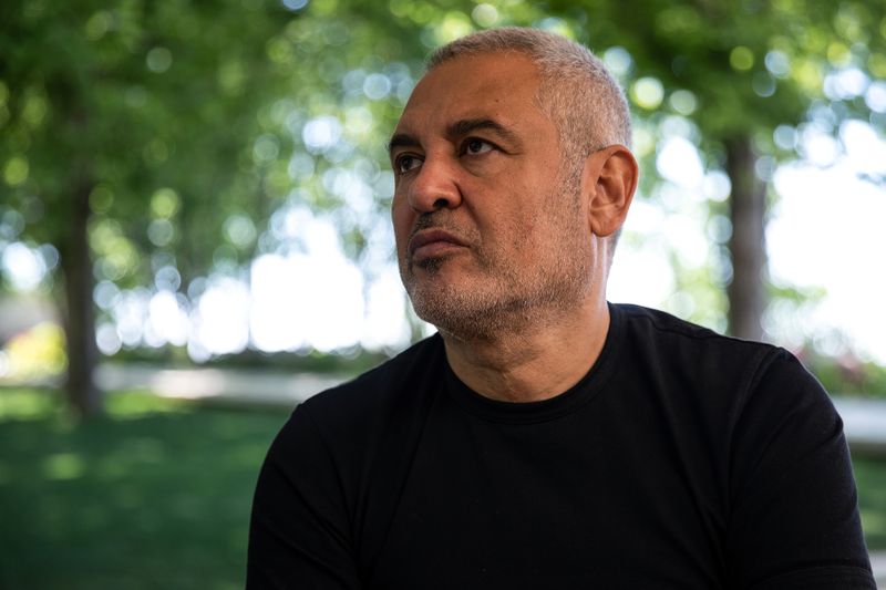 © Reuters. Lebanese fashion designers Elie Saab looks on during an interview with Reuters, following a massive explosion at the Beirut port area, in Faqra