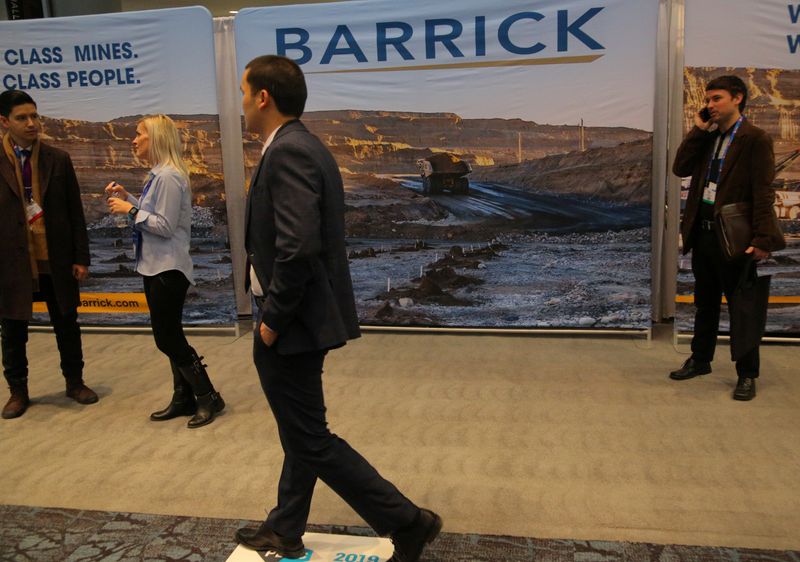 &copy; Reuters. A visitor passes a Barrick Gold mining company display during the PDAC convention in Toronto