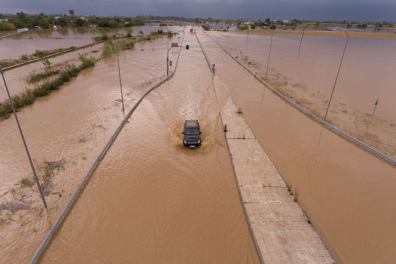 &copy; Reuters. A car is seen on a flooded highway following a storm near the village of Artesiano