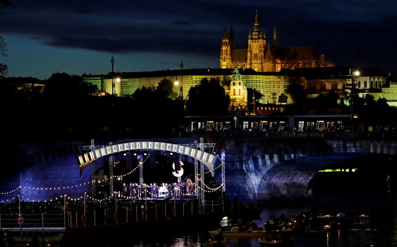 &copy; Reuters. People watch a classical concert on a floating stage in Prague