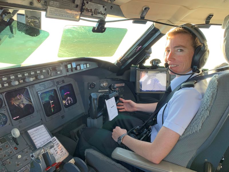 &copy; Reuters. PSA pilot Megyn Thompson in the cockpit of a Bombardier CRJ jet near Washington